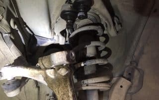 Car suspension with coil spring and control arm