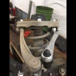 Car suspension strut and control arm on workbench