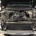 Car engine bay exposed in auto repair shop