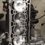 Four-cylinder engine block with visible pistons