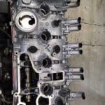 Automotive engine cylinder head with exposed camshafts