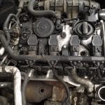Close-up of car engine components and hoses