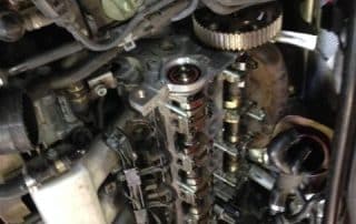 Car engine with exposed camshaft and timing components