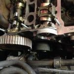 Close-up of car engine camshaft and timing gear