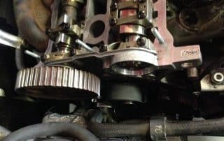 Close-up of car engine camshaft and timing gear
