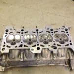 Automotive engine cylinder head with exposed valves