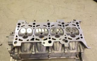 Automotive engine cylinder head with exposed valves