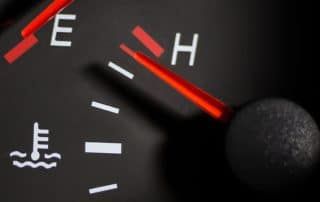 Car temperature gauge needle near hot mark