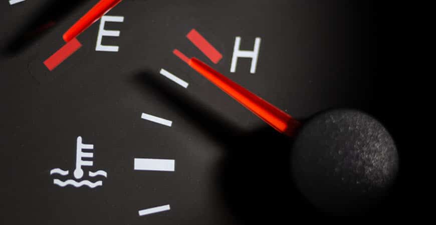 Car temperature gauge needle near hot mark