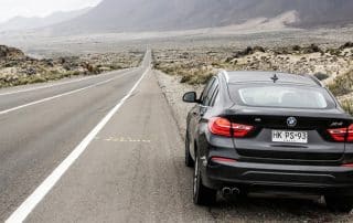 Black BMW X4 on desert highway
