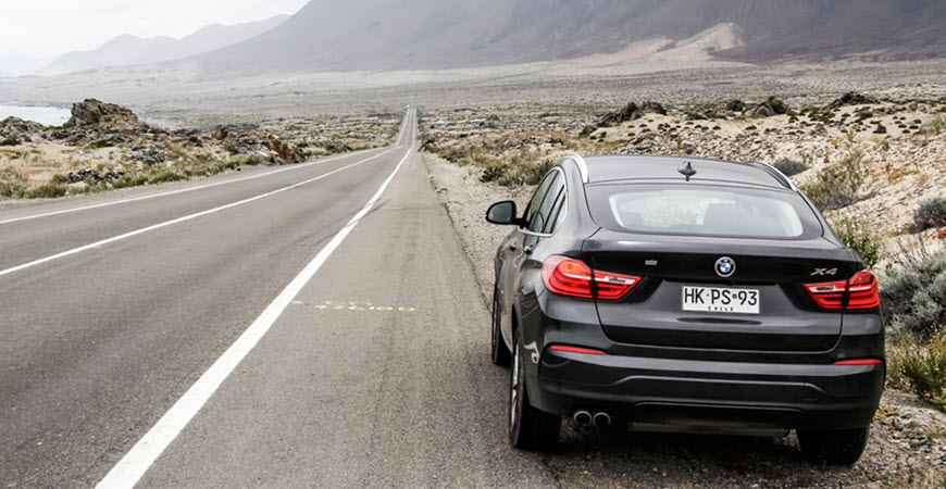 Black BMW X4 on desert highway