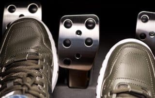 Feet on car pedals in manual transmission vehicle
