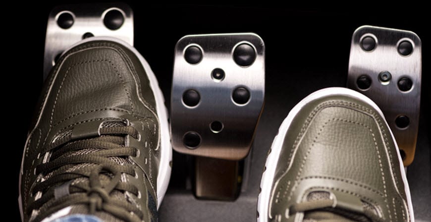 Feet on car pedals in manual transmission vehicle