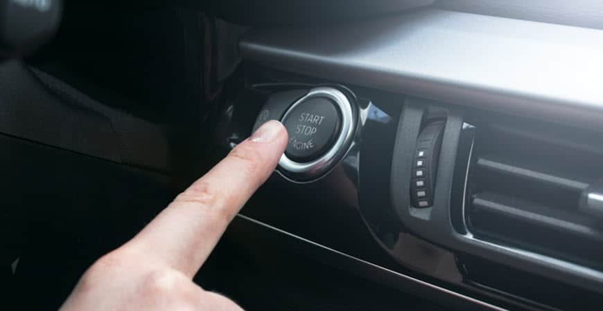 Finger pressing car start-stop engine button