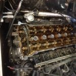 Exposed car engine with visible camshafts and components