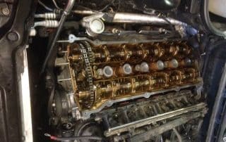 Exposed car engine with visible camshafts and components