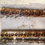 Engine cylinder heads and camshaft on workshop floor