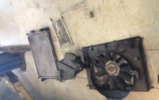 Car radiator and cooling fan assembly on floor
