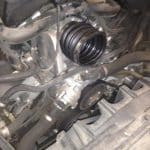 Car engine bay with exposed intake hose