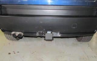 Rear bumper with trailer hitch and dual exhaust