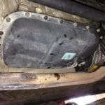 Underside of car showing oil pan and exhaust