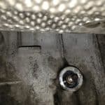 Close-up of engine block with spark plug hole