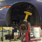 Car on lift with exposed brake assembly