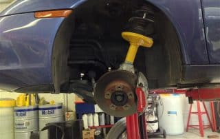 Car on lift with exposed brake assembly