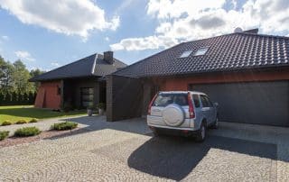 Modern single-story home with SUV in driveway