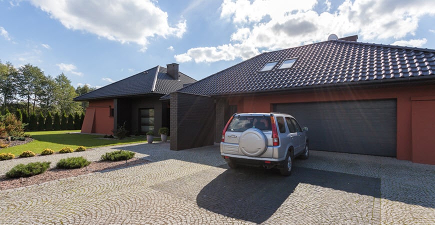 Modern single-story home with SUV in driveway