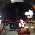 Car on lift with exposed brake rotor