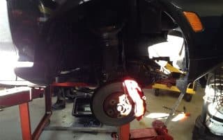 Car on lift with exposed brake rotor