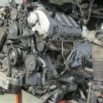 Car engine mounted on stand in garage