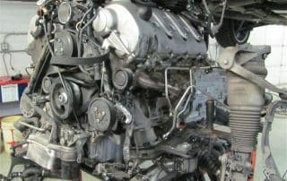 Car engine mounted on stand in garage