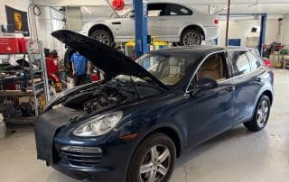 Porsche SUV in auto repair shop