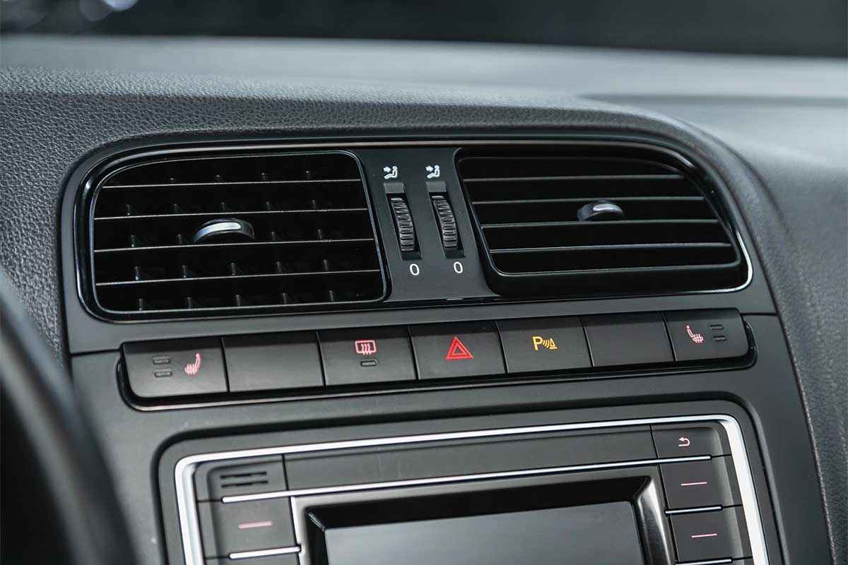 Car dashboard with air vents and control buttons