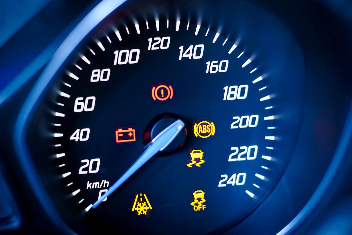 European Auto Check Engine Light Diagnostics in Denver image Car dashboard speedometer with warning lights illuminated