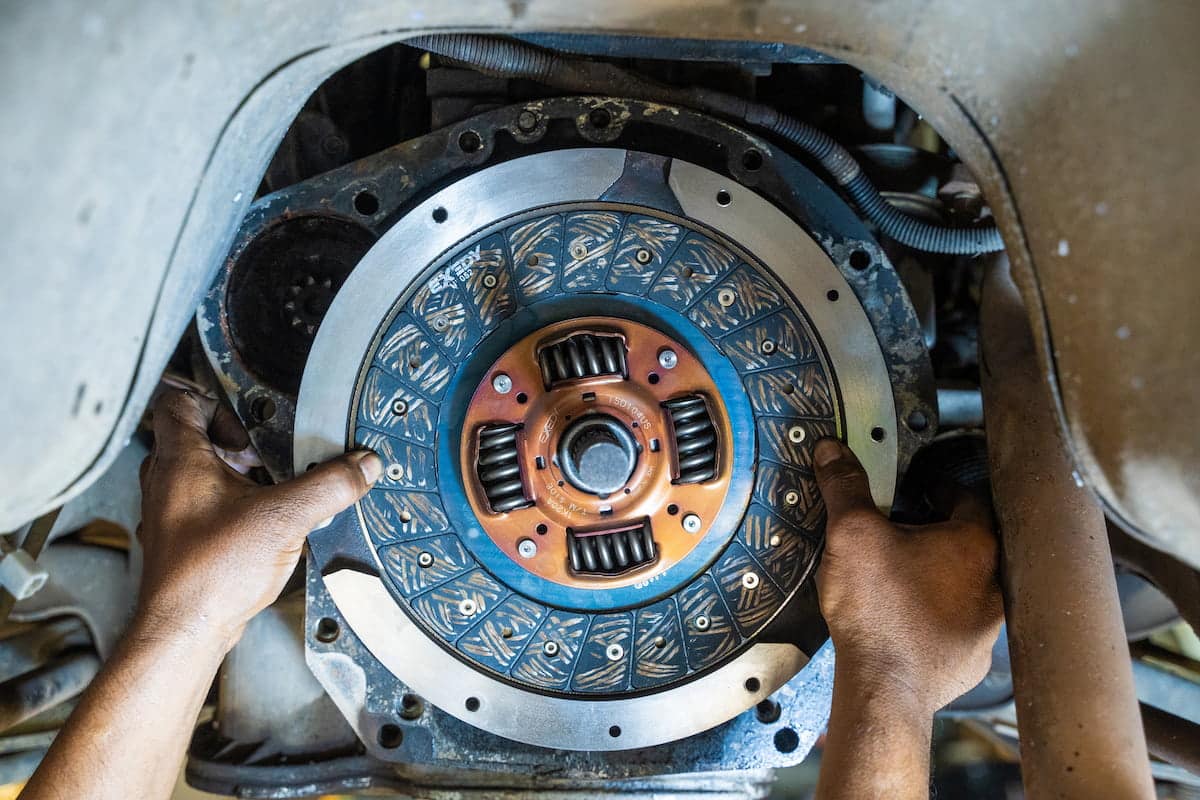 European Auto Clutch Repair & Replacement in Denver image Mechanic installing clutch disc in vehicle transmission