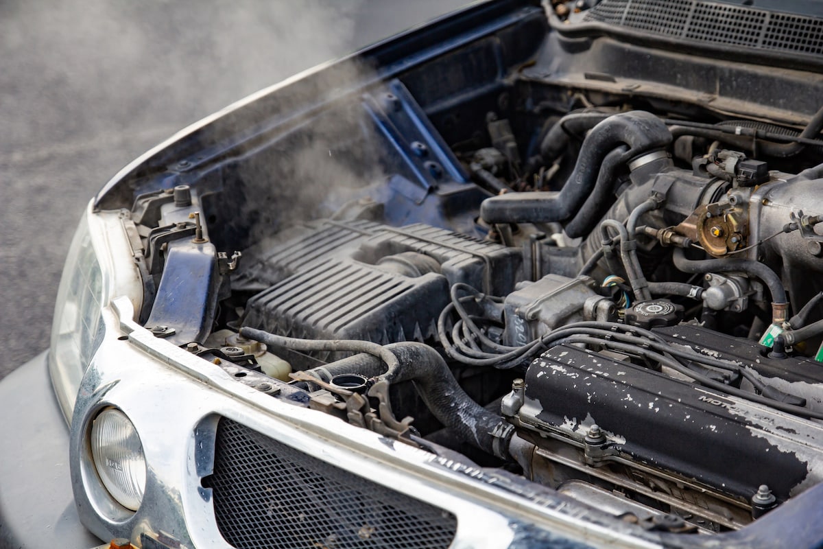 European Auto Coolant Leak Repair in Denver image Car engine overheating with steam under open hood
