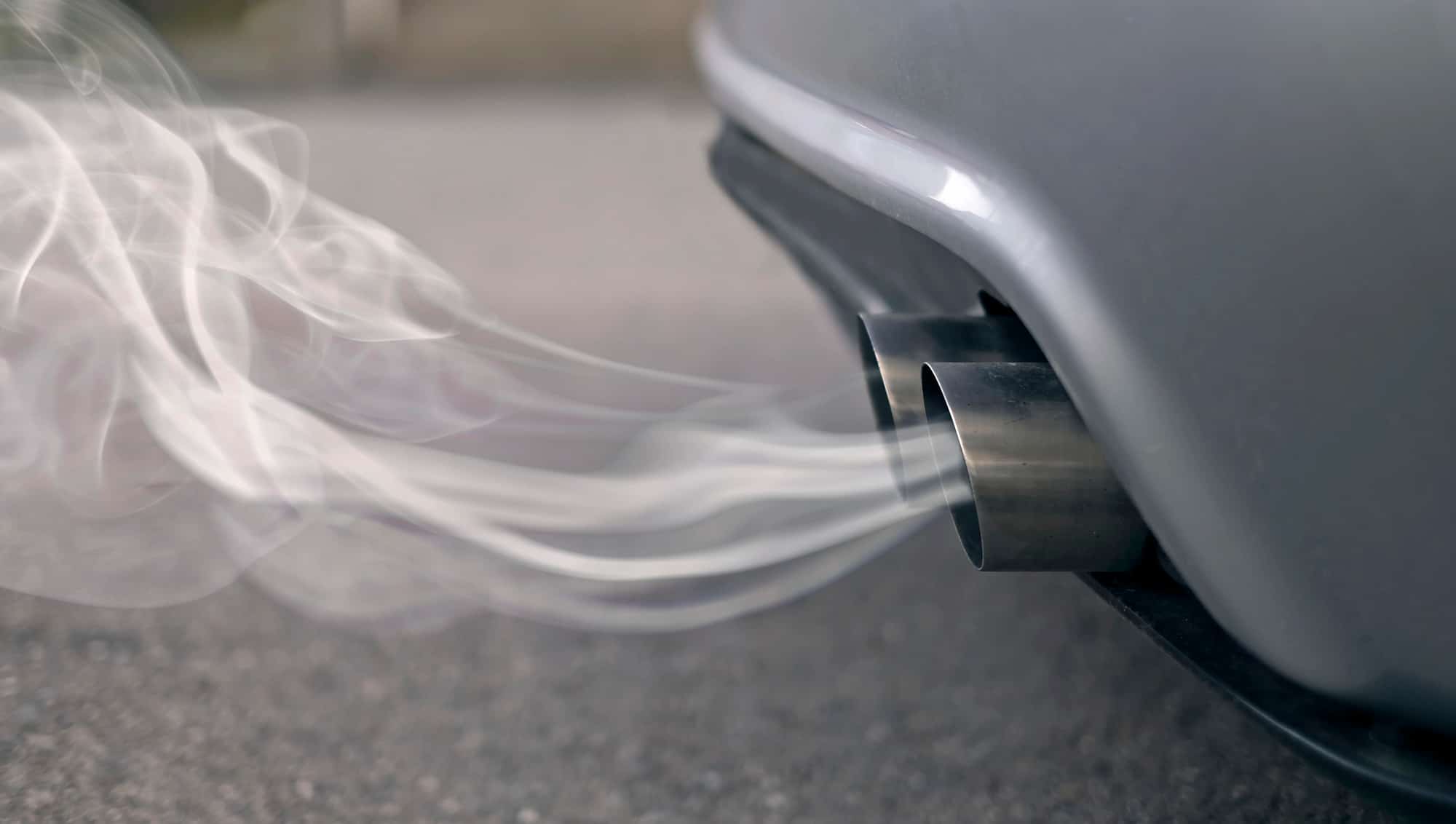 Car exhaust pipe emitting white smoke