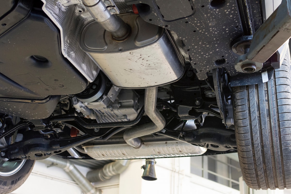 European Auto Exhaust & Catalytic Converter Repair in Denver image Underside of car showing exhaust and suspension