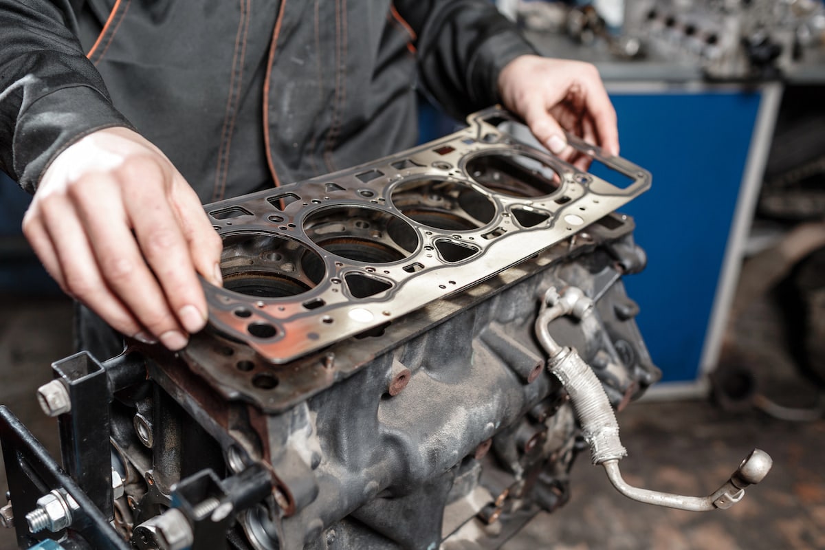 European Auto Head Gasket Repair & Replacement in Denver image Mechanic installing head gasket on engine block