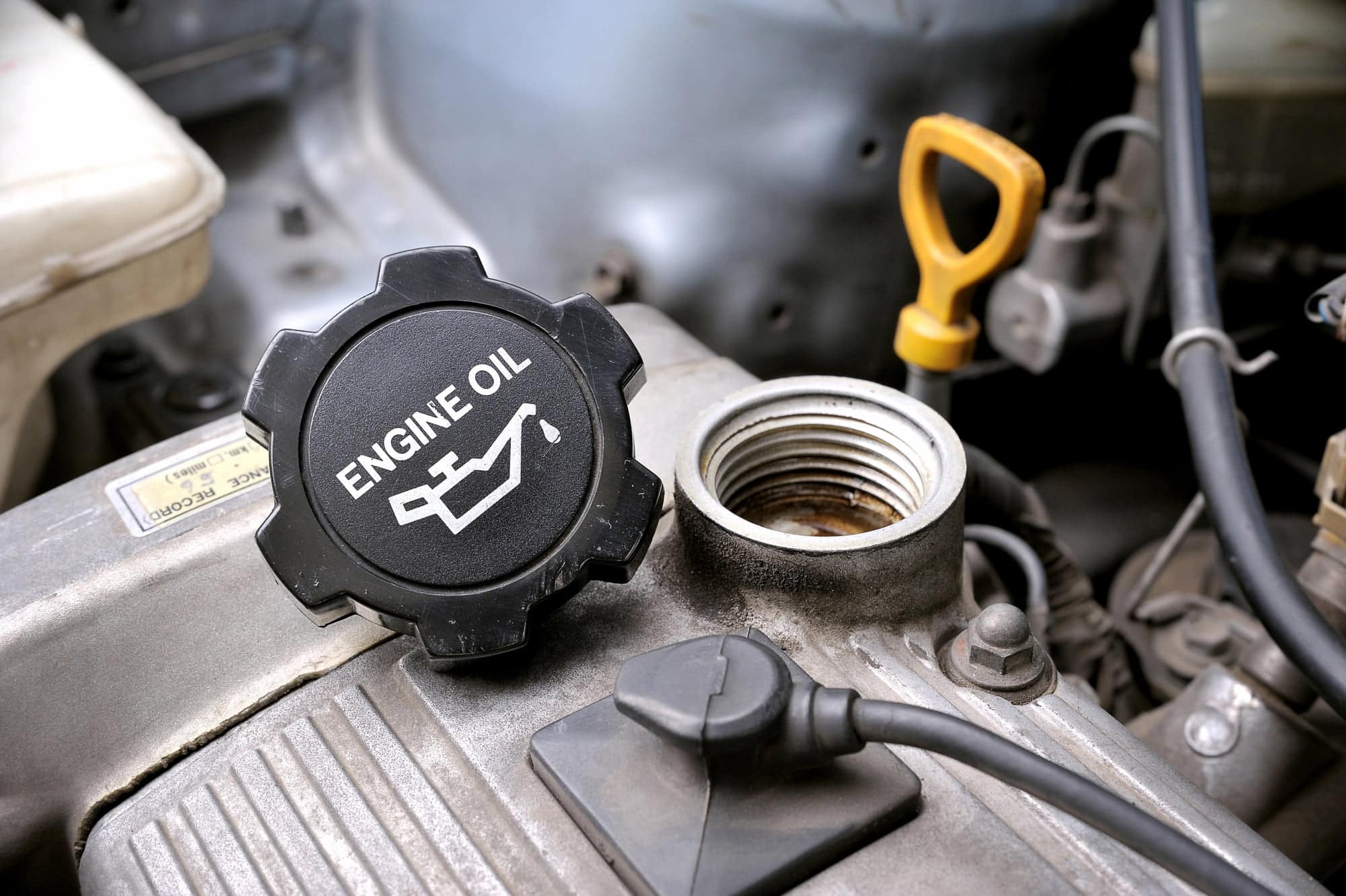 Car engine oil cap and dipstick close-up
