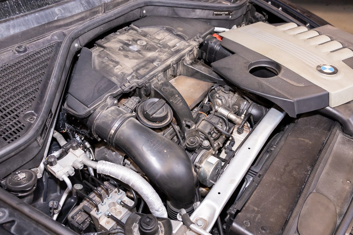 Dusty BMW engine bay with components exposed