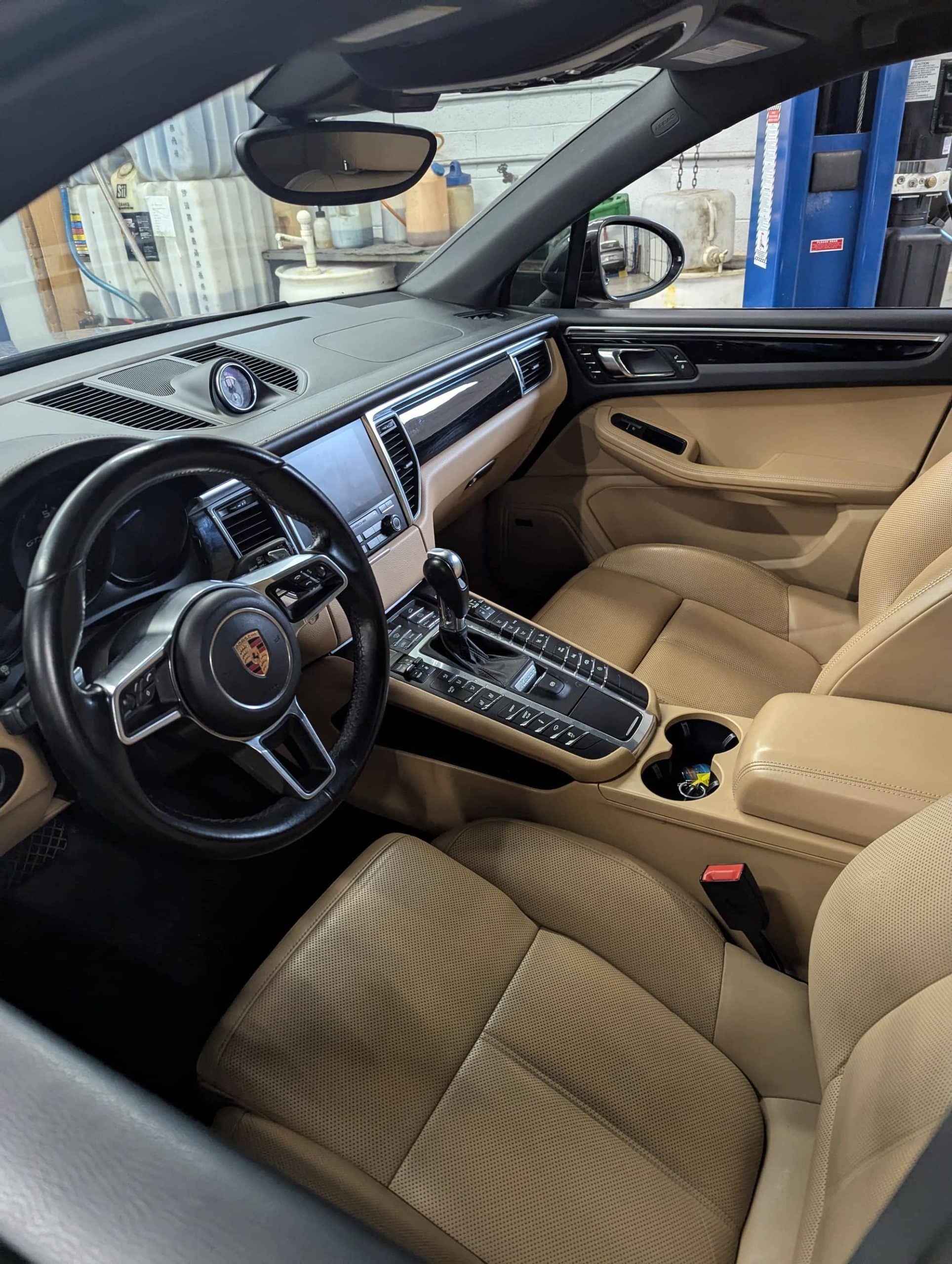 Beige leather Porsche SUV interior with dashboard view