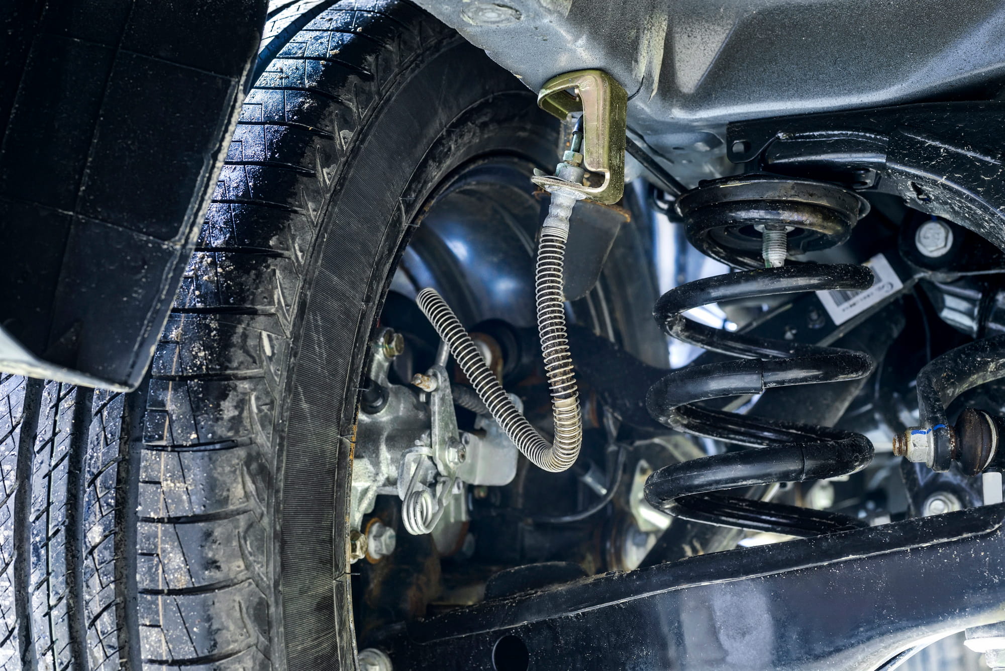 Car suspension and rear wheel underside close-up
