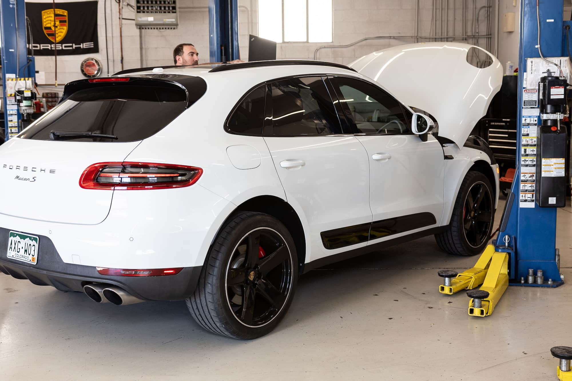 White Porsche Macan S in auto repair shop