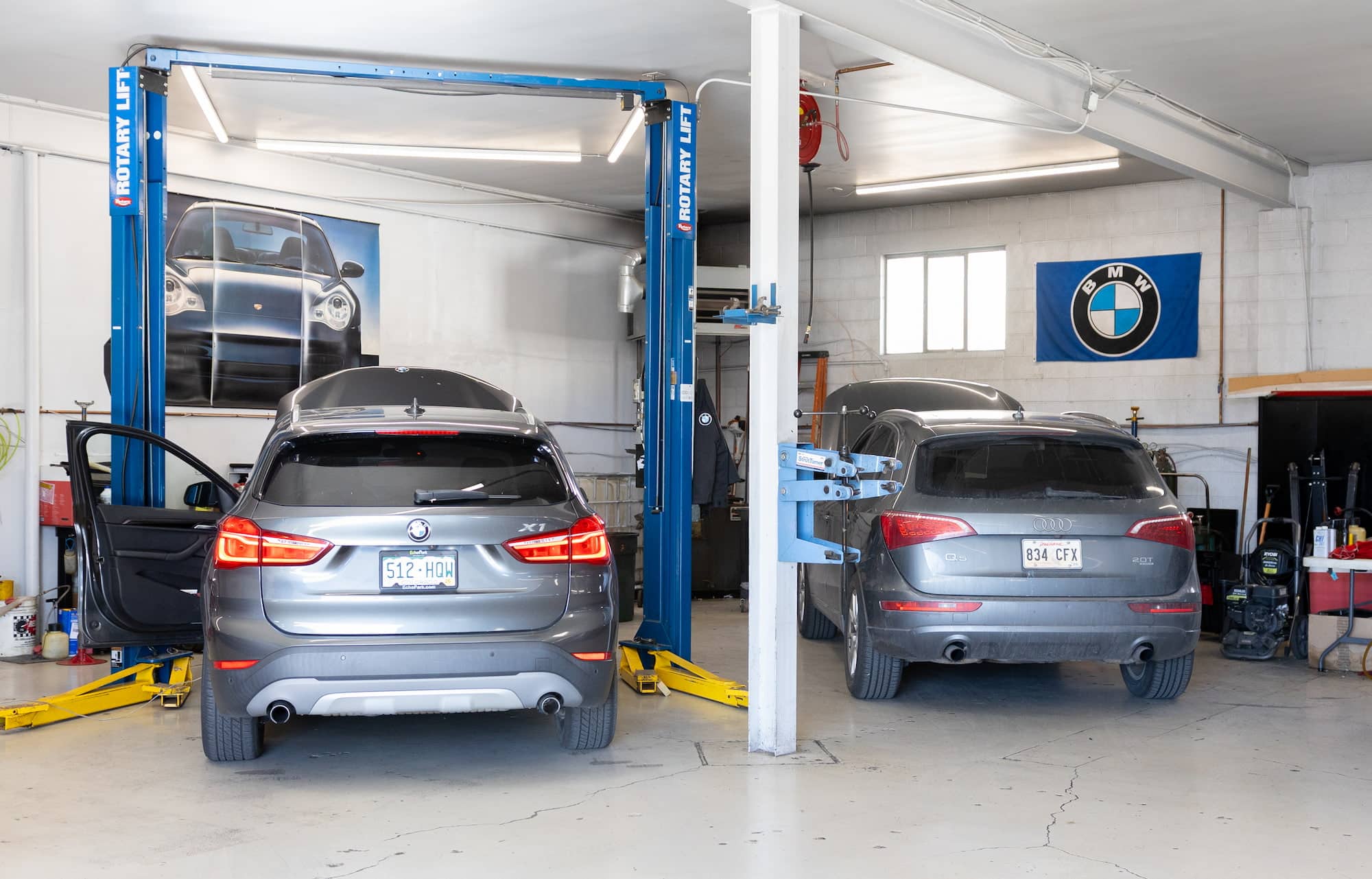 BMW and Audi SUVs in auto repair shop
