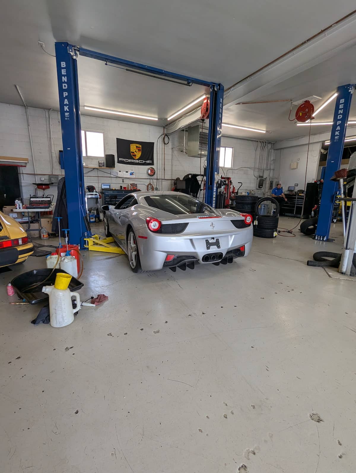 European Auto Wheel Alignment in Denver image Silver Ferrari in auto repair shop on lift