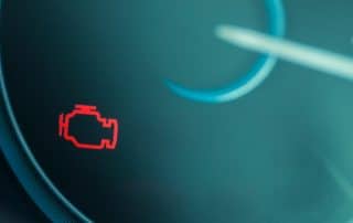 Car dashboard with check engine warning light